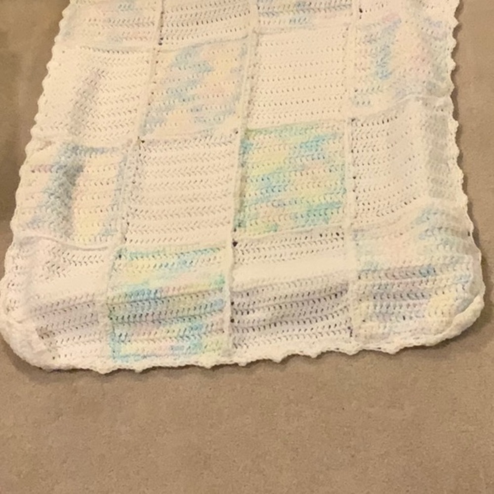 A beautiful hand crocheted baby blanket.  Brand new.